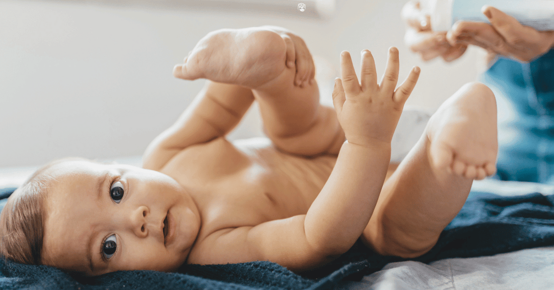 A mother changes her baby's diaper.