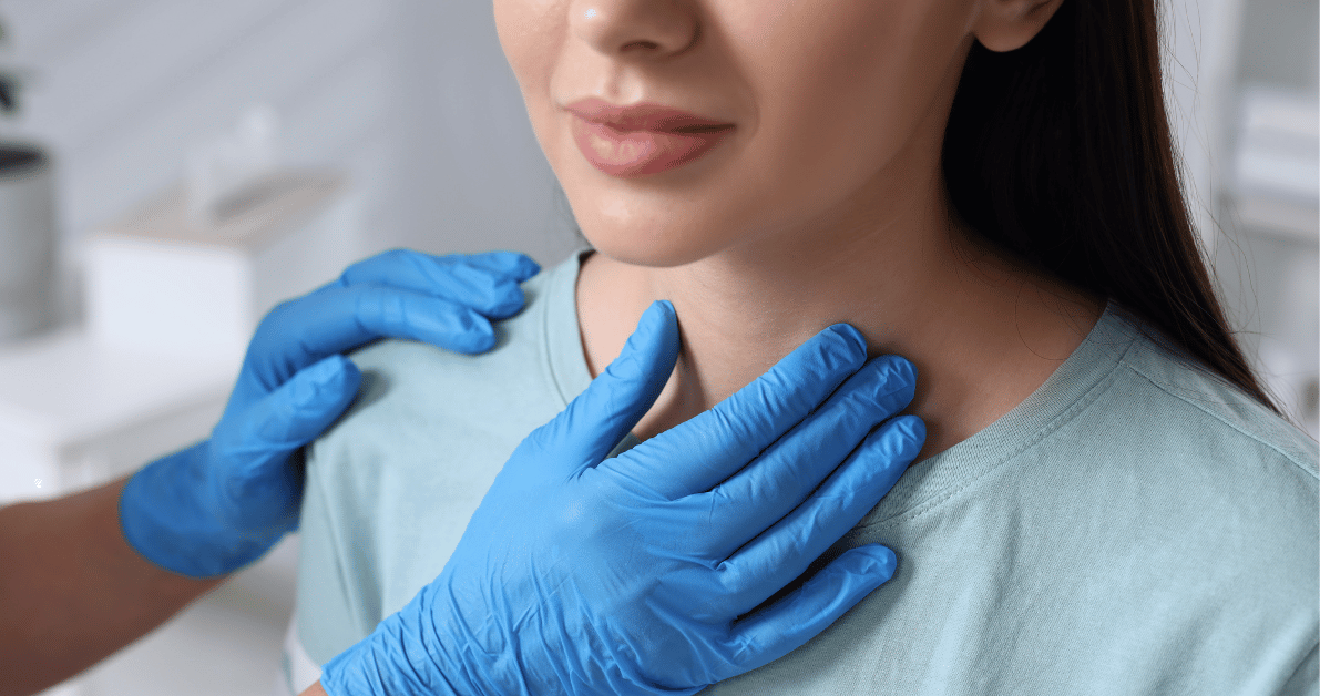 A woman's neck is examined by a doctor.