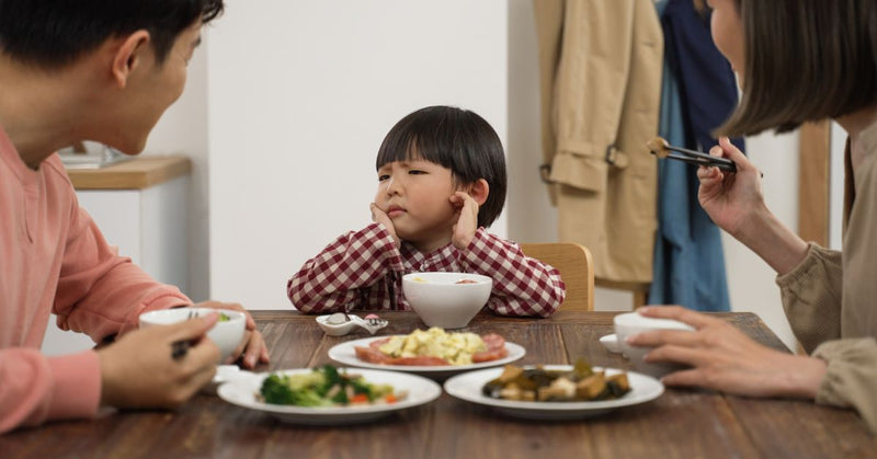 A boy refuses to eat healthy foods.