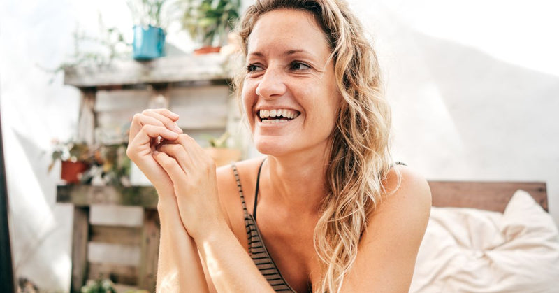 A forty plus year old woman smiles.
