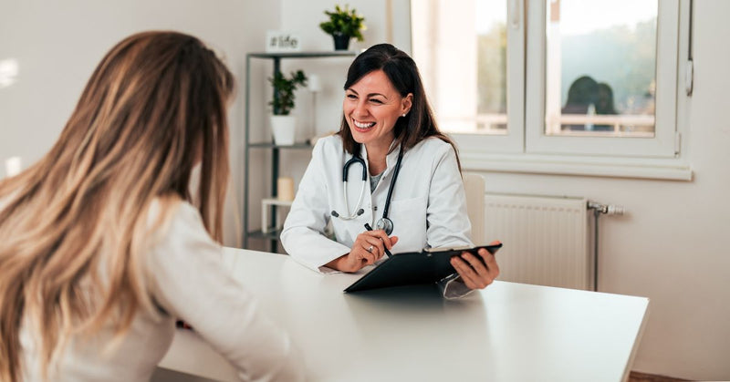 A doctor talks with her female patient. 