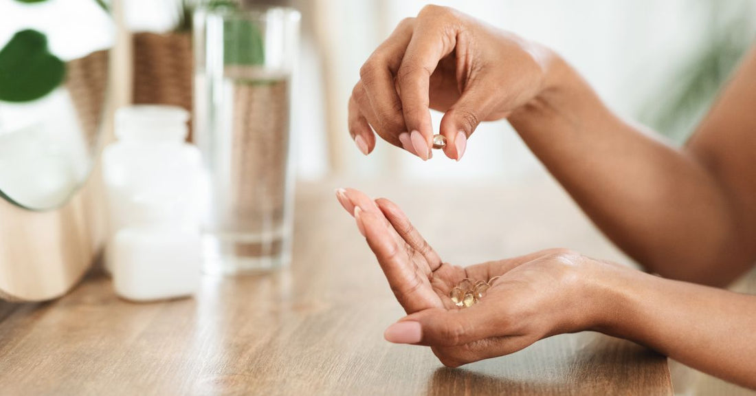 A woman's hands hold vitamin D supplements.
