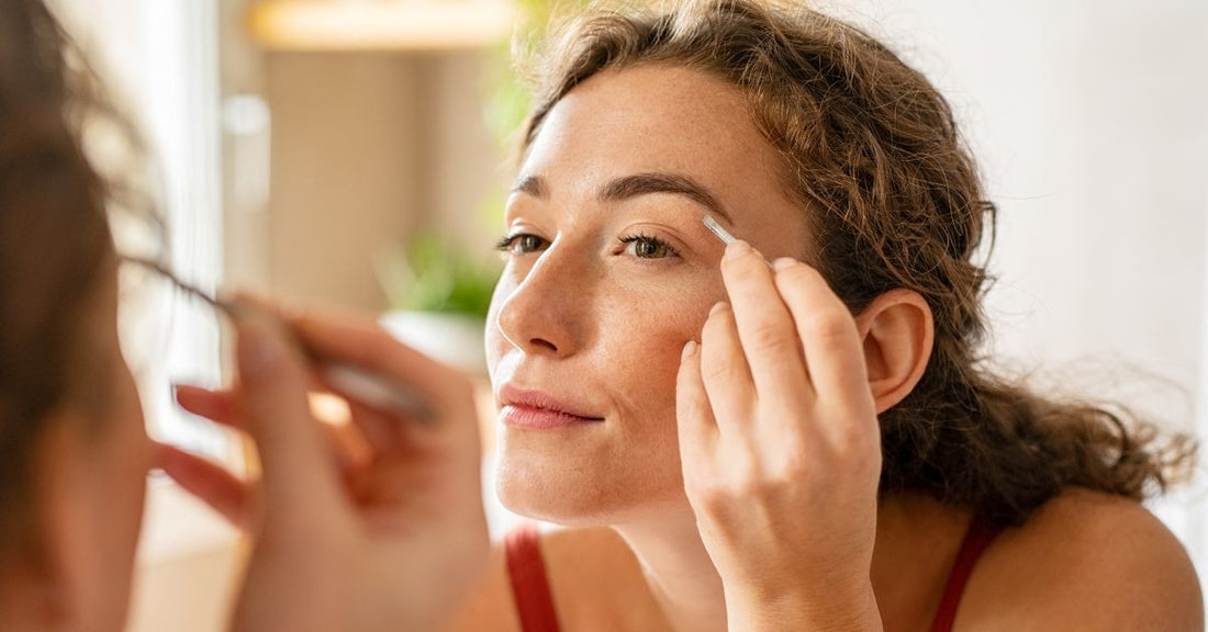 A woman looks at her fade closely in a mirror. 