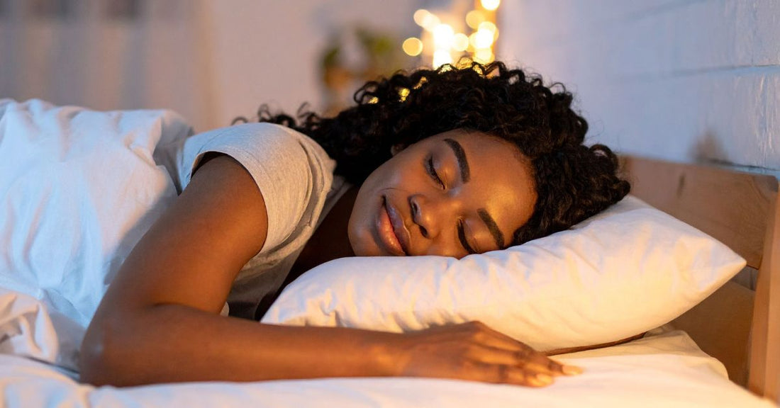 A woman sleeps peacefully in her bed.